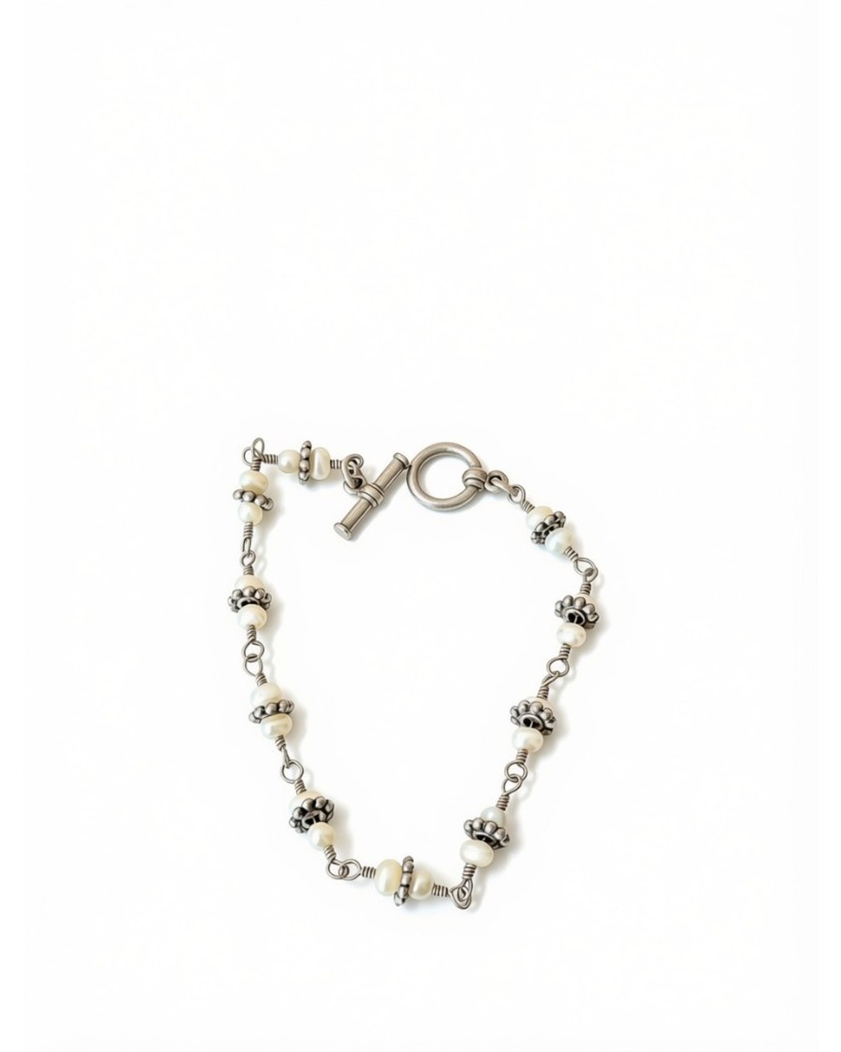 Pearl link bracelet with silver floral bead caps